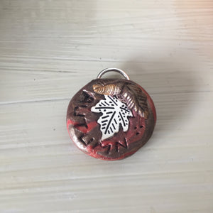 Handcrafted autumn token with leaf design